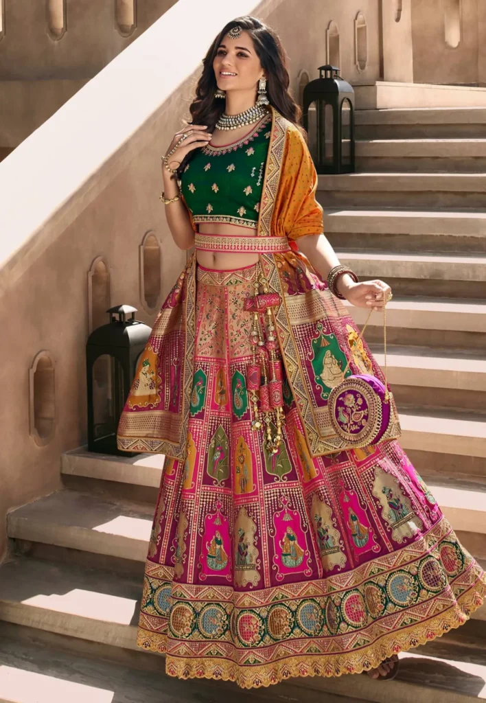 Bride wearing a vibrant pink ghagra choli with mirror work at a Sangeet ceremony.