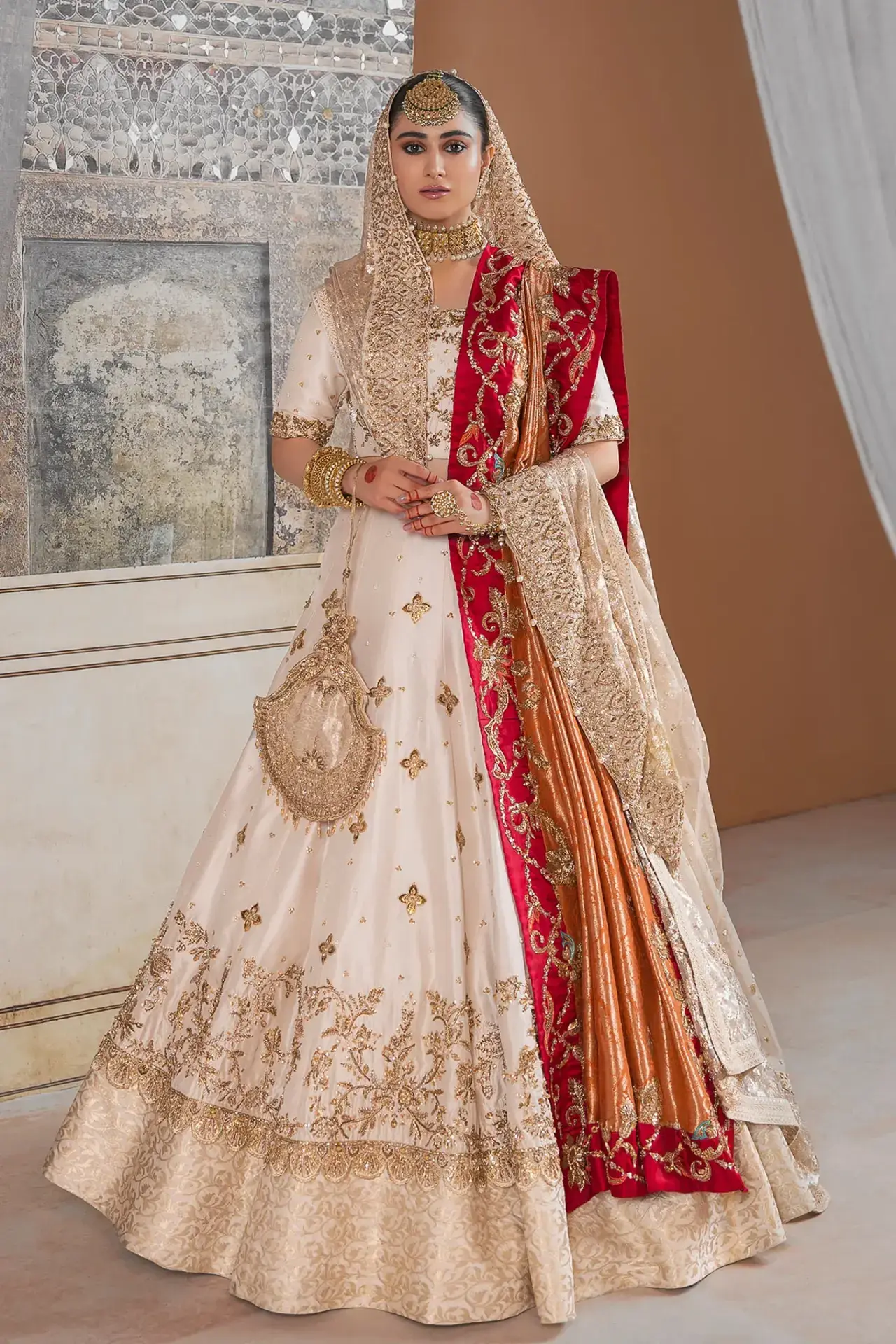 A bride wearing a pastel pink chiffon Nikah dress with delicate lace detailing.